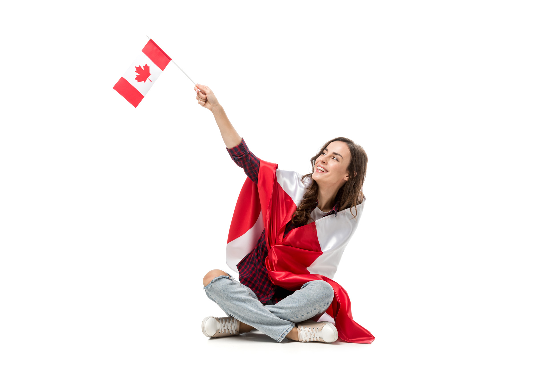 woman covered in canadian flag waving with maple