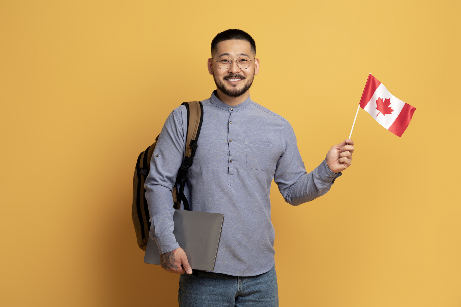 man with canadian flag and laptop