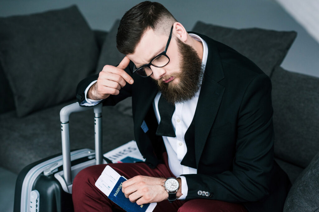 Business traveler looking worried with passport in hand