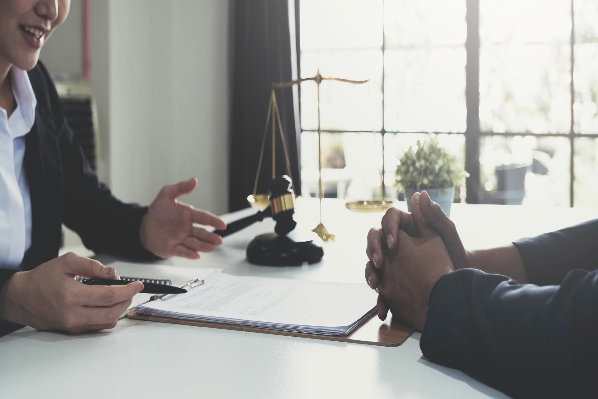 Woman consulting lawyer on legal papers
