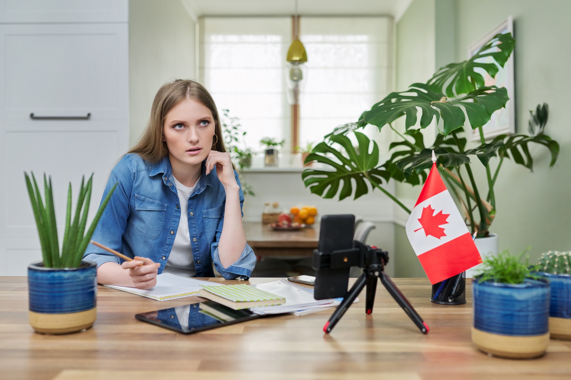 Woman studying with Canadian flag on table