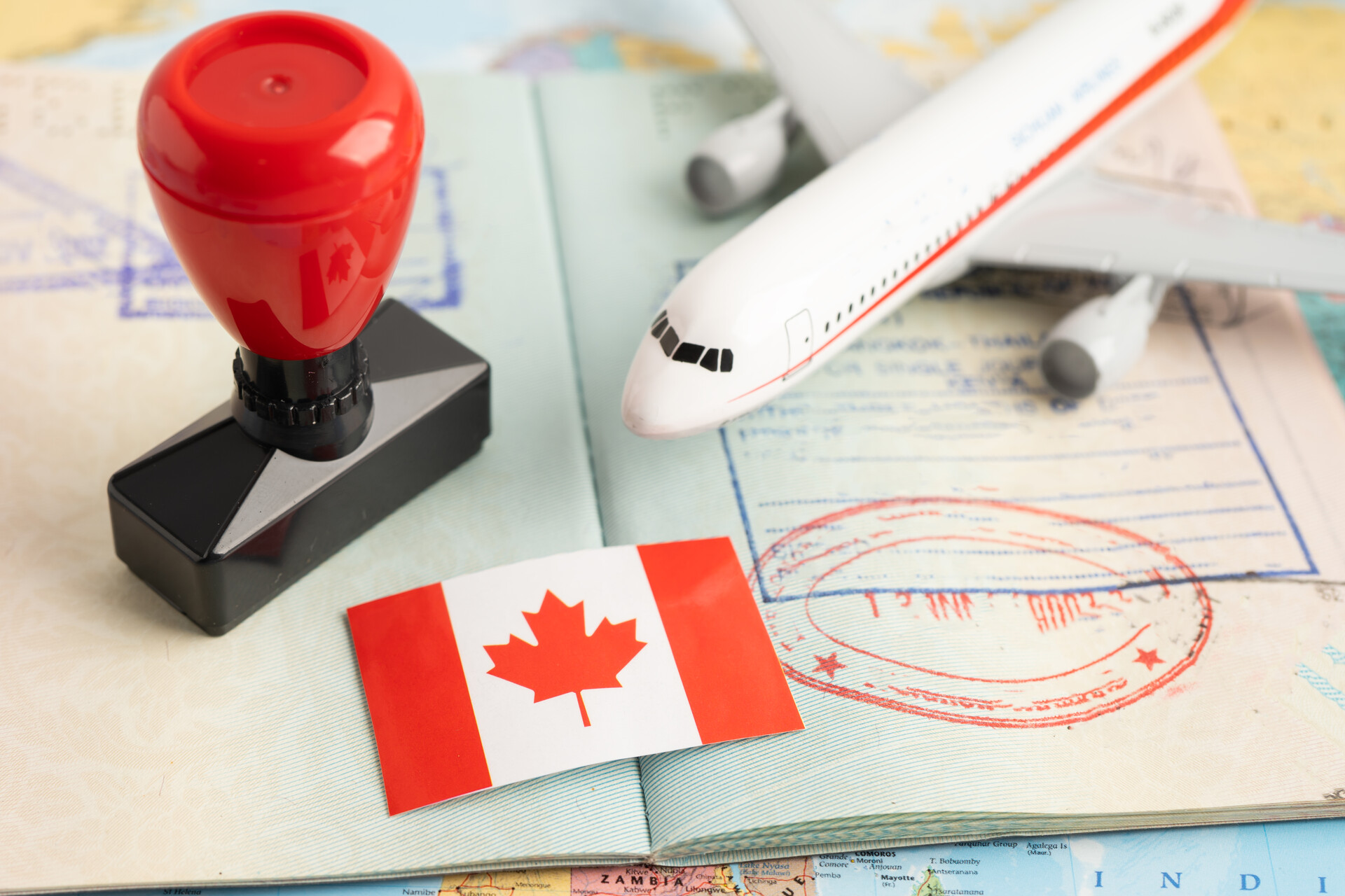 Canadian visa stamp, flag, and airplane