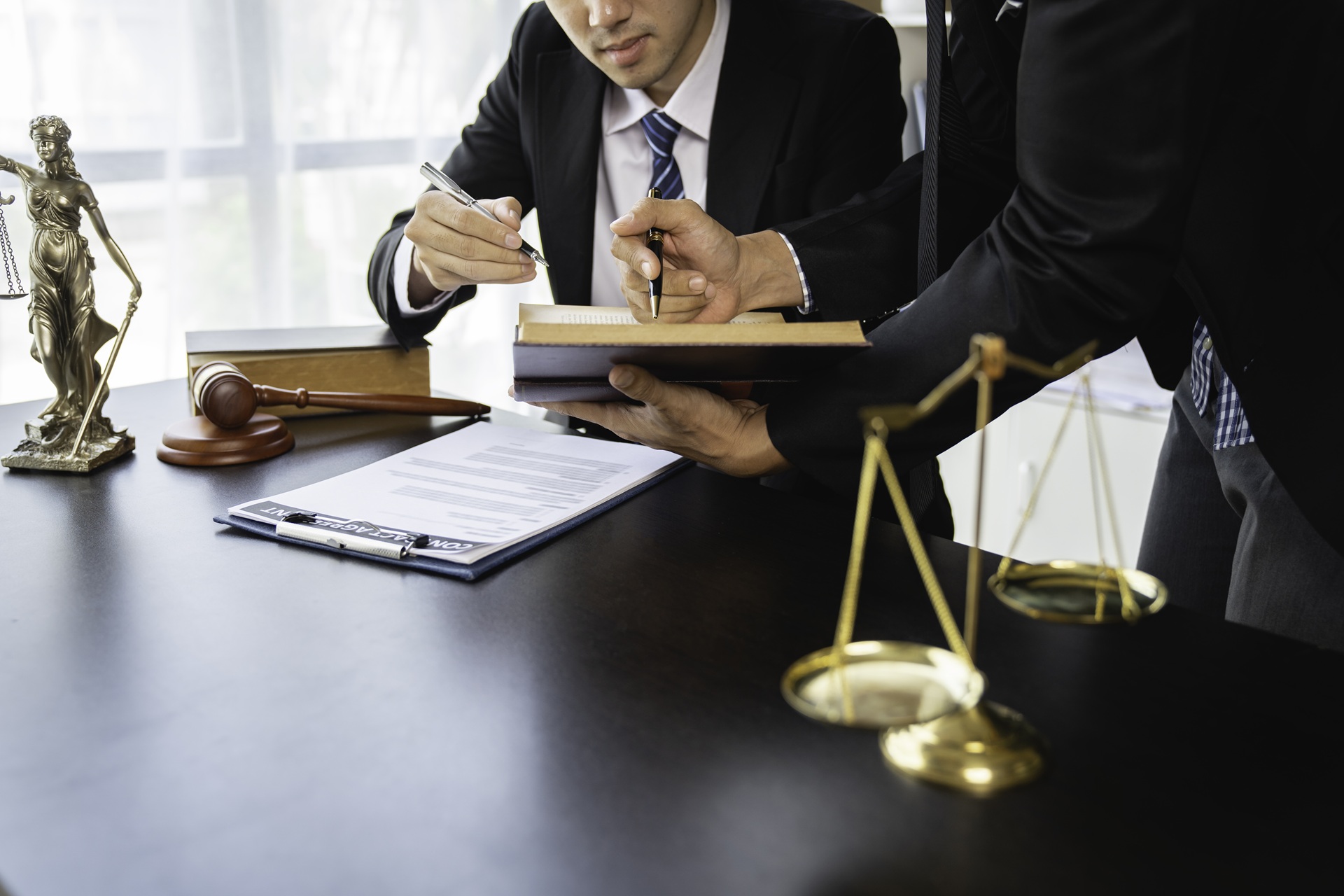 Two legal professionals reviewing a document