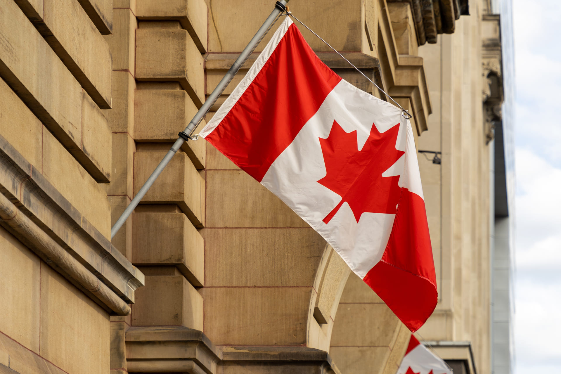 Canadian flag on government building facade
