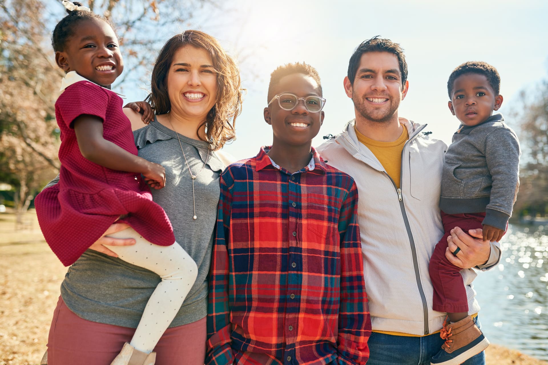 Happy multicultural family posing together outdoors