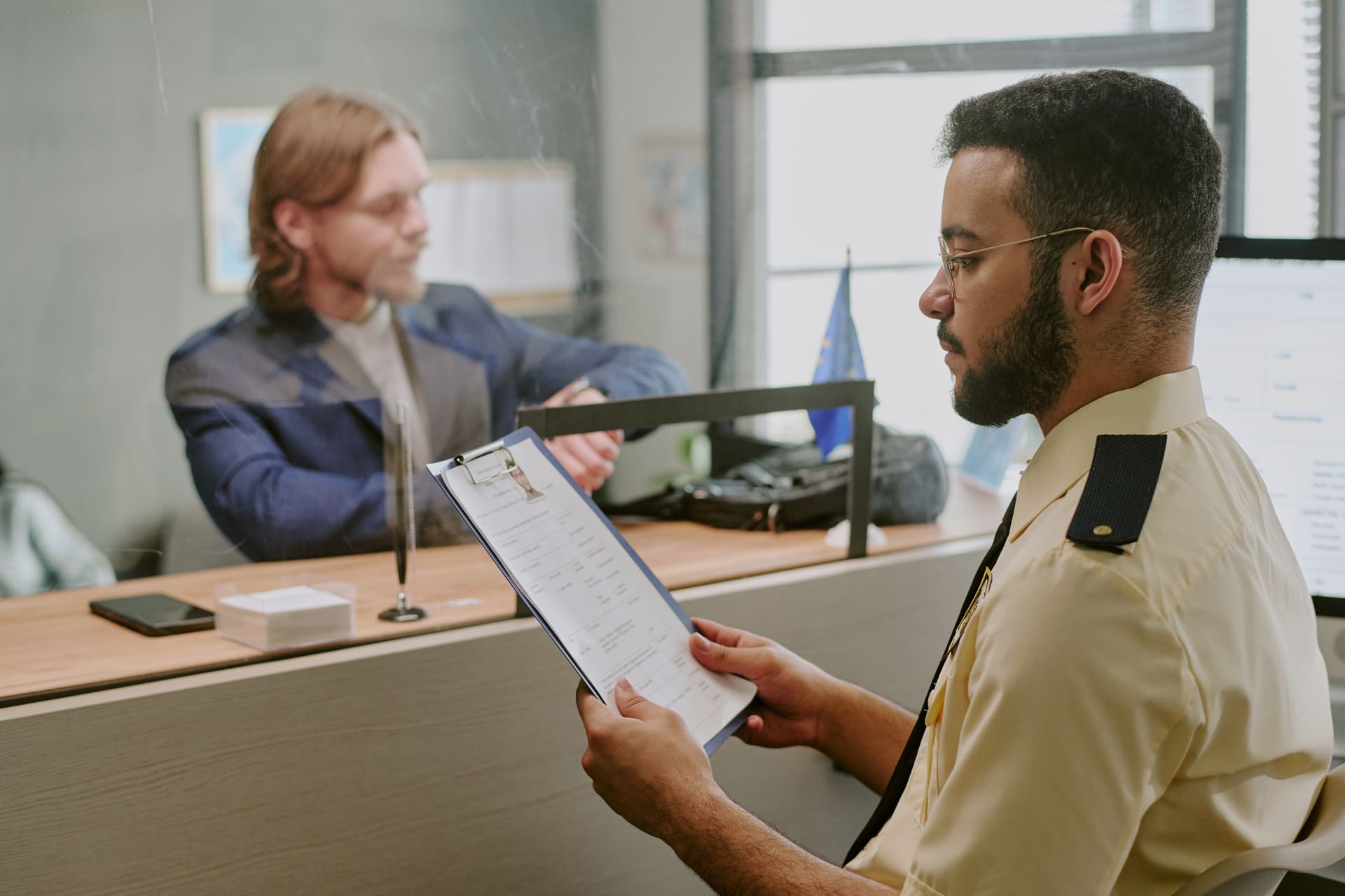 Officer reviewing visa application at service counter