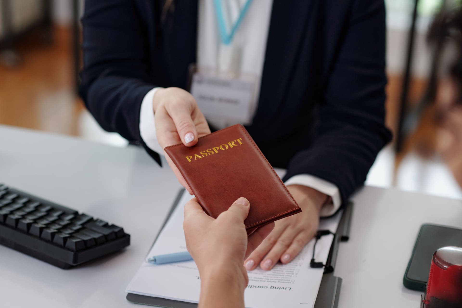 Submitting passport to officer at service counter