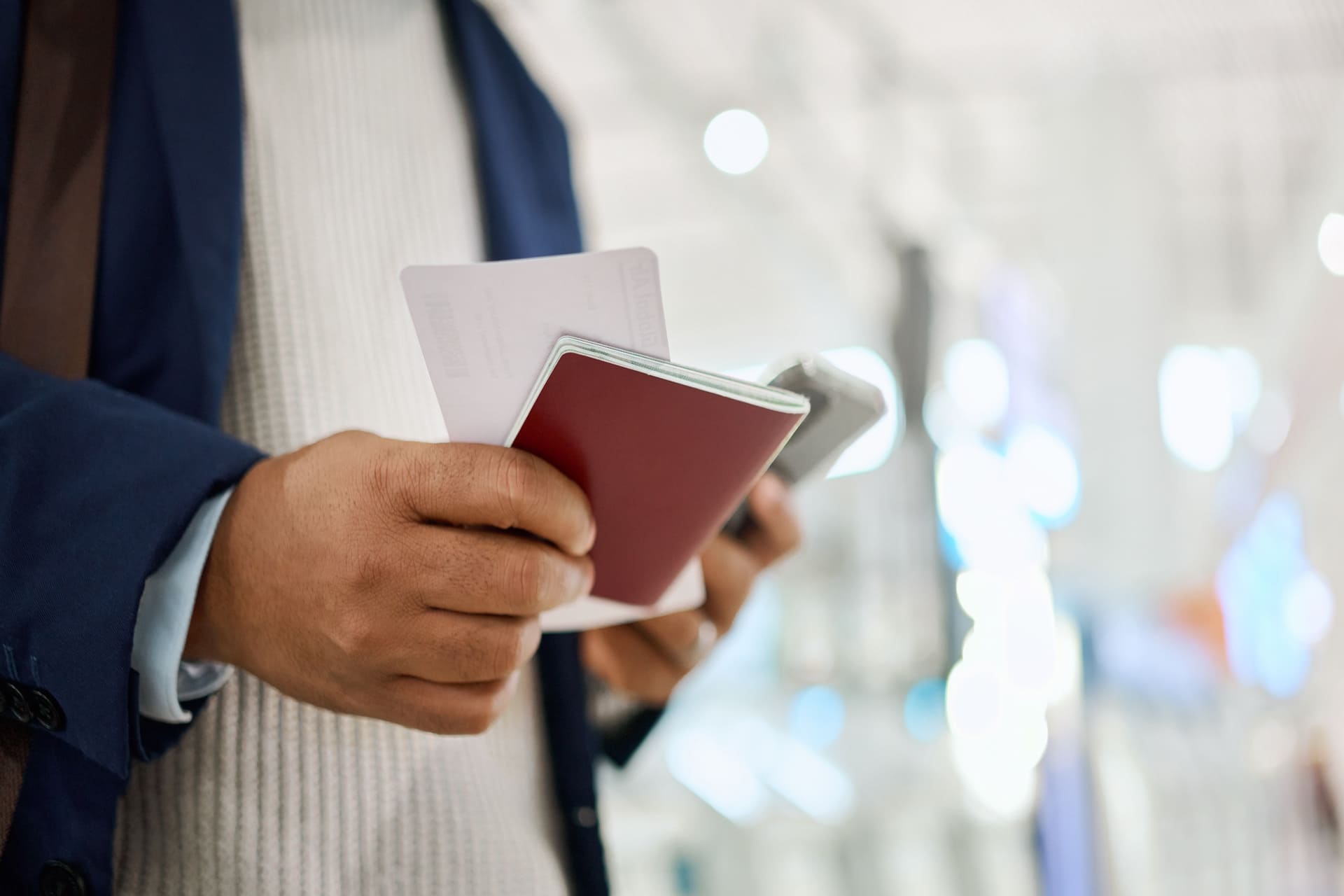 man holding passport and card
