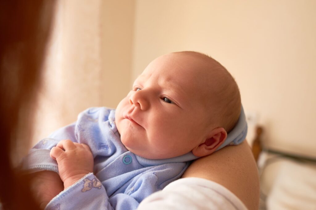 Newborn baby in the hands of a parent