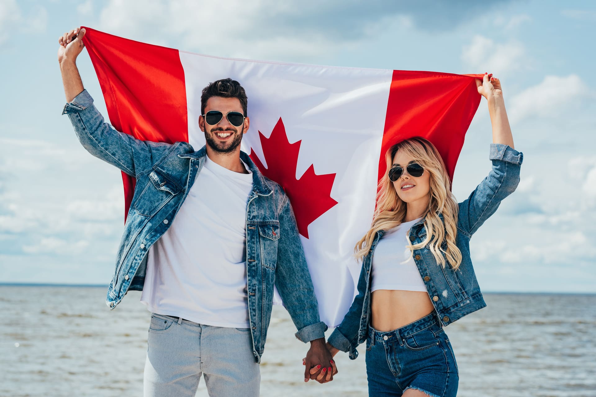 Happy couple waiving Canadian flag