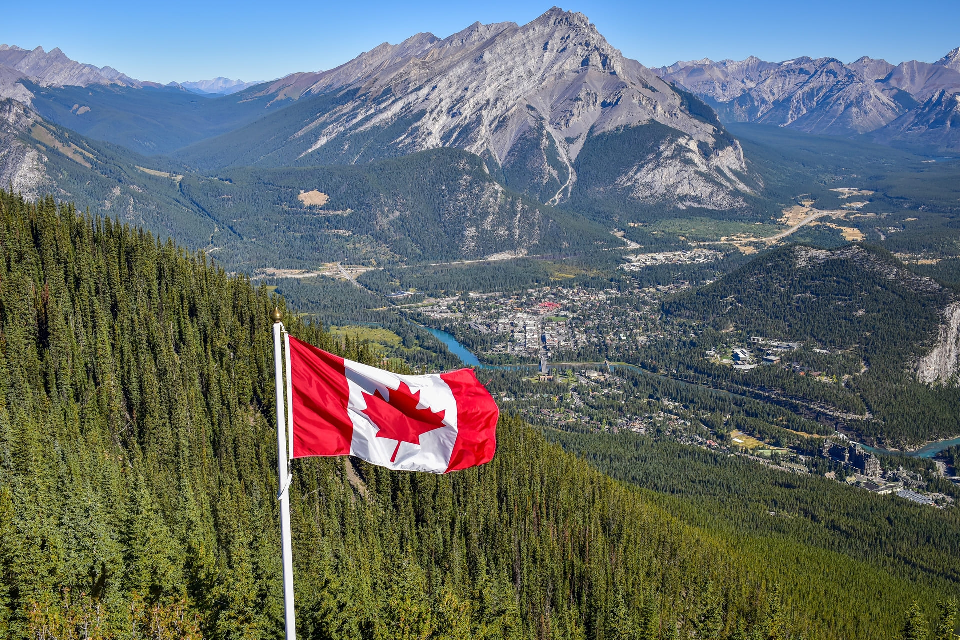 Canadian flag with mountains in background