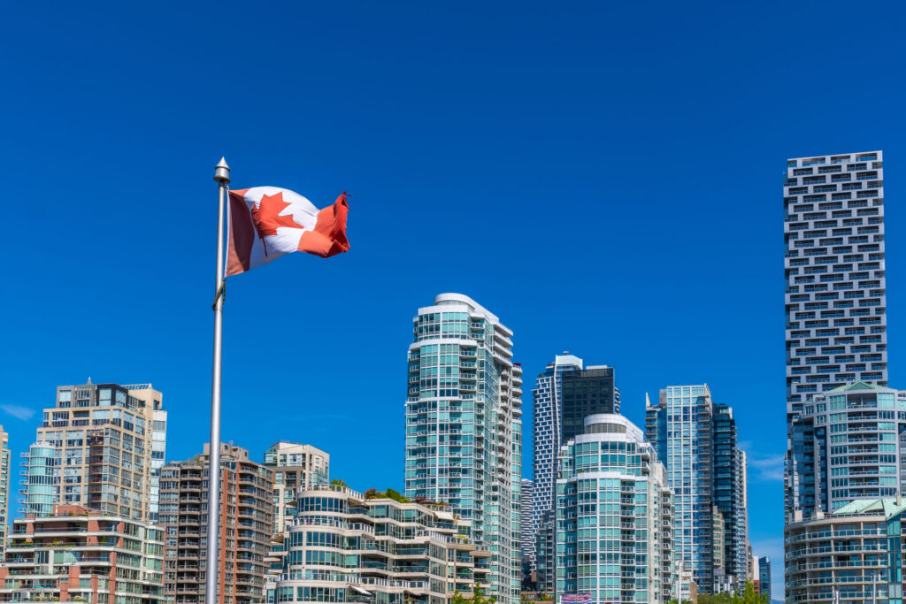 Canadian flag waving with bustling city in the background