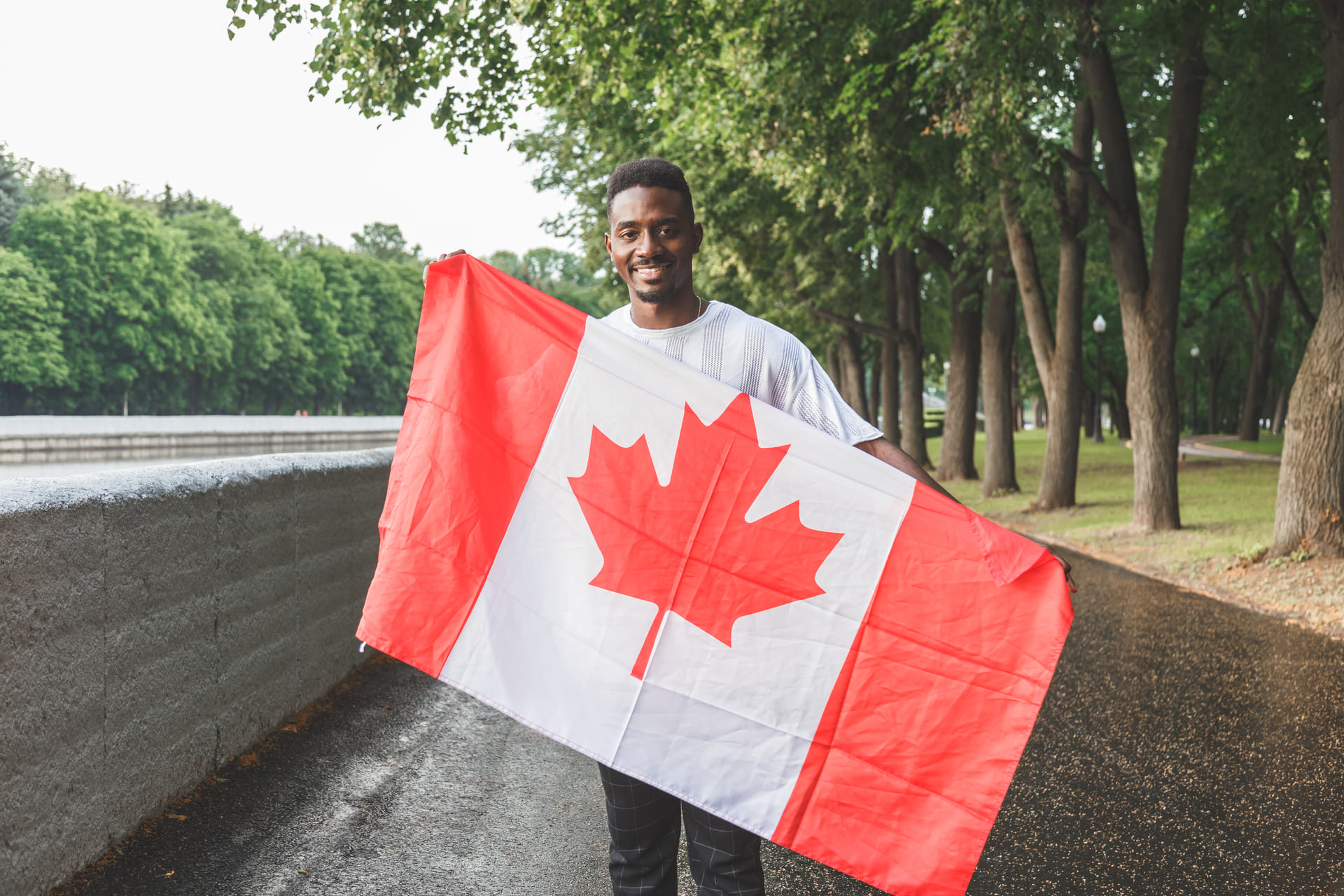 man holding canadian flag