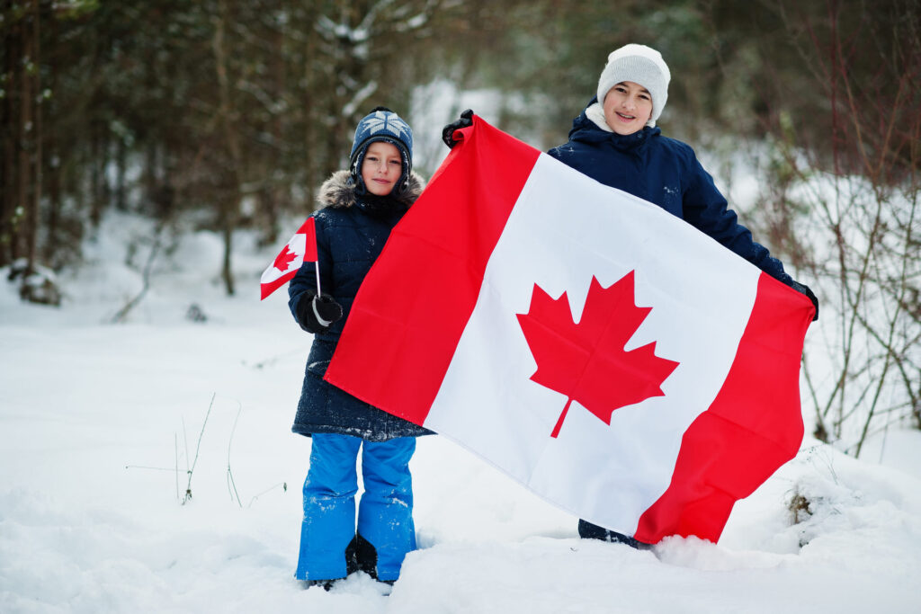 boys holding the Canadian flag