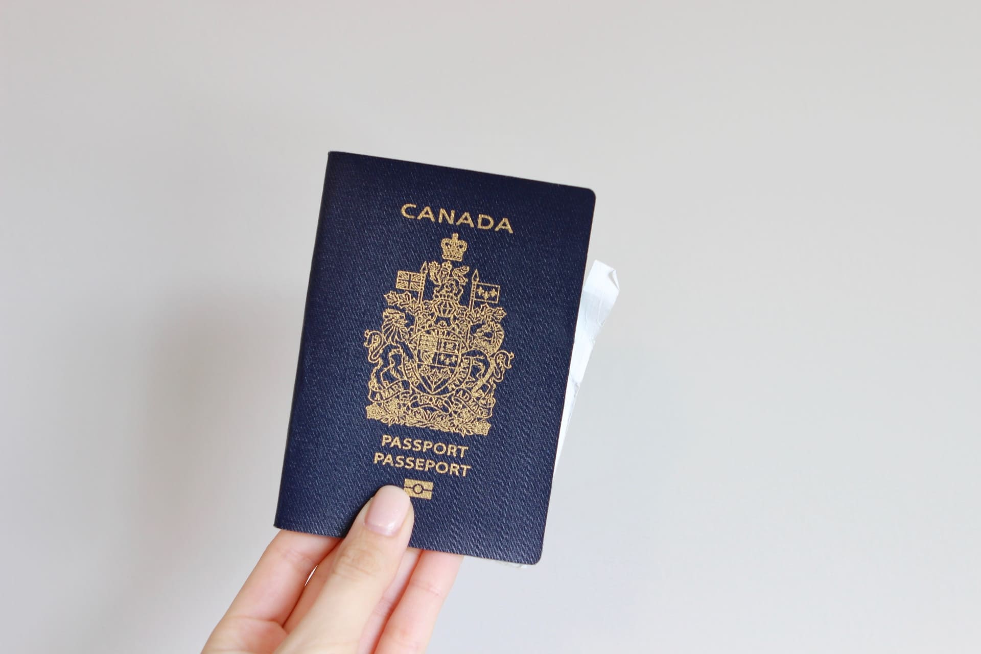 Hand holding Canadian Passport