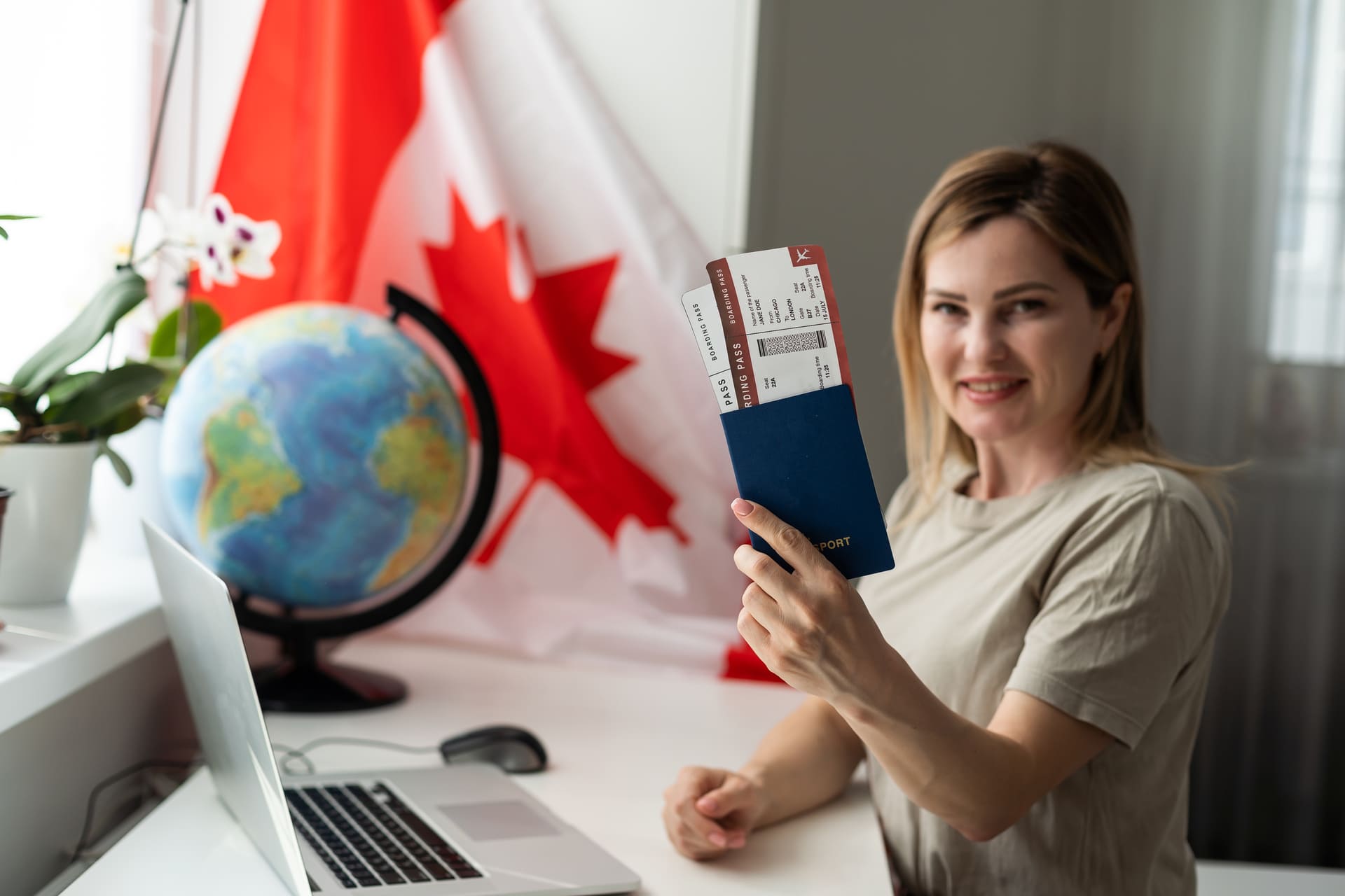 woman holding up canadian passport