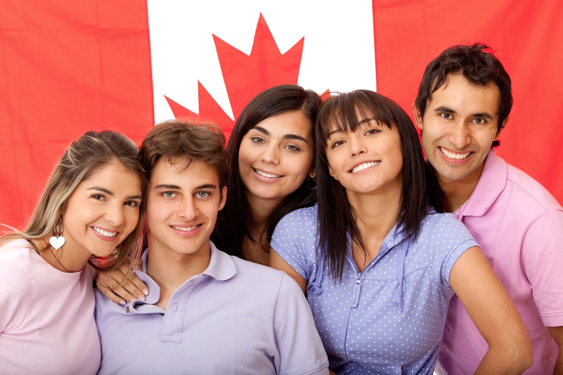 group of people in front of canadian flag