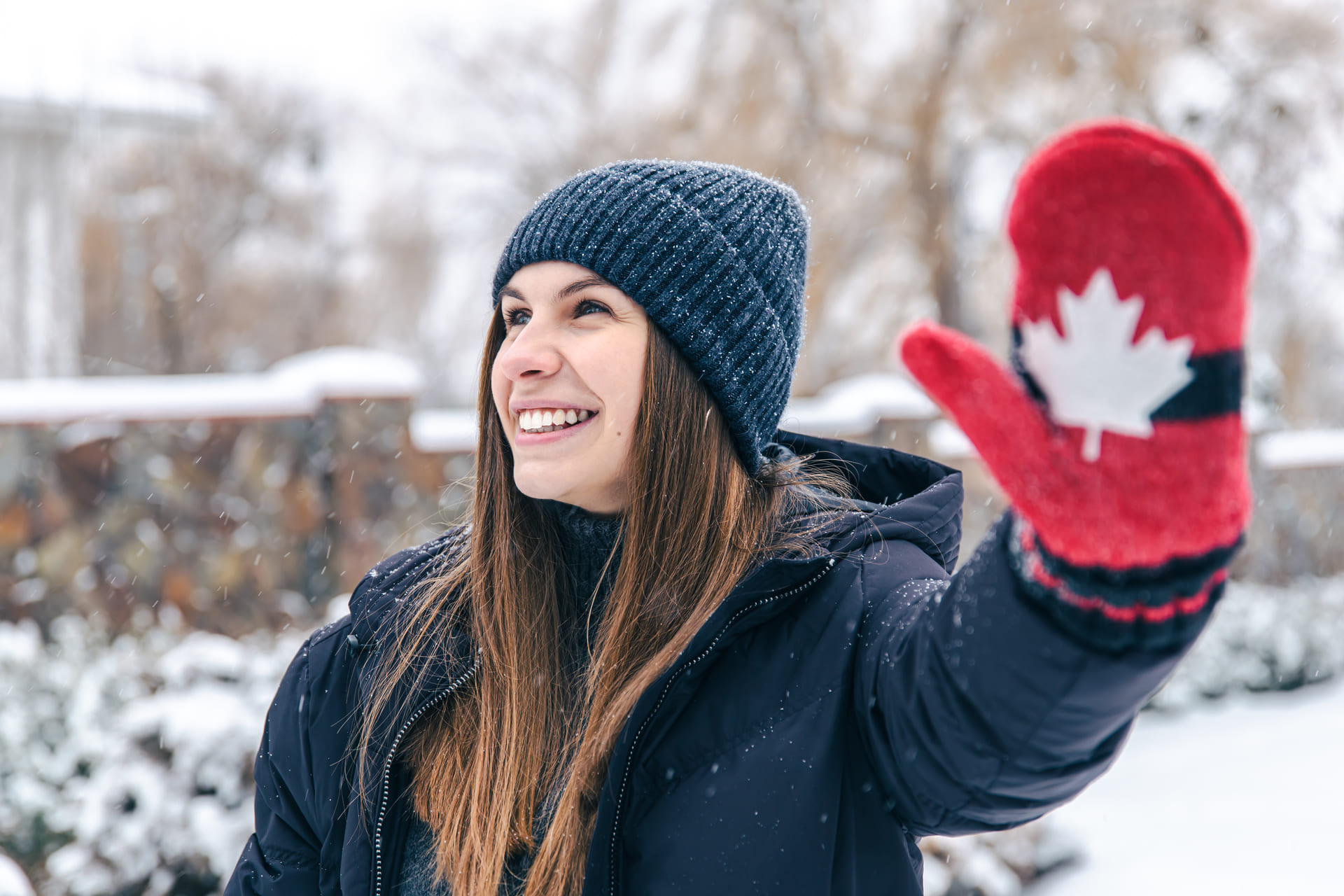 happy young woman with canadian gloves