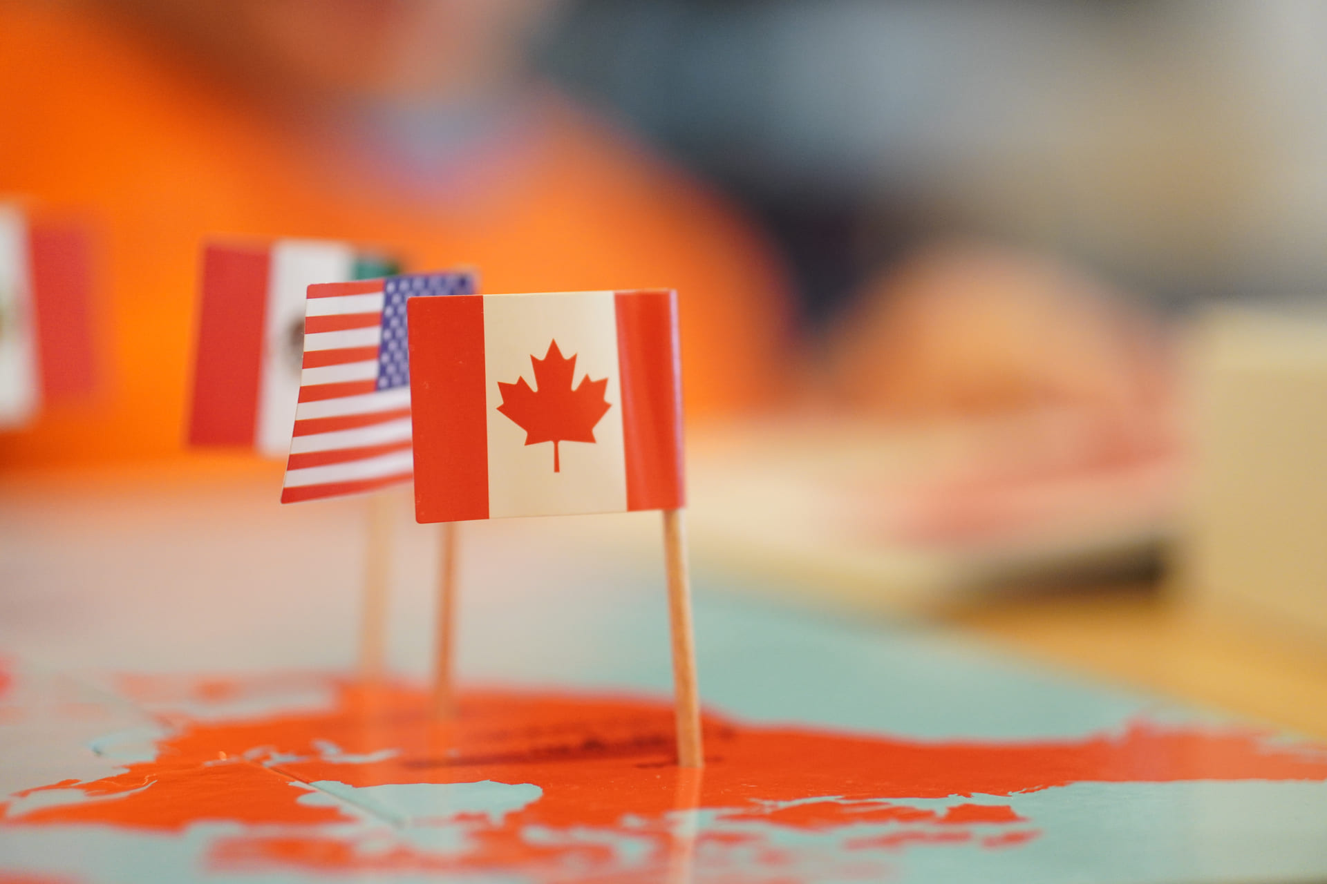 focus shot on canadian and USA flag