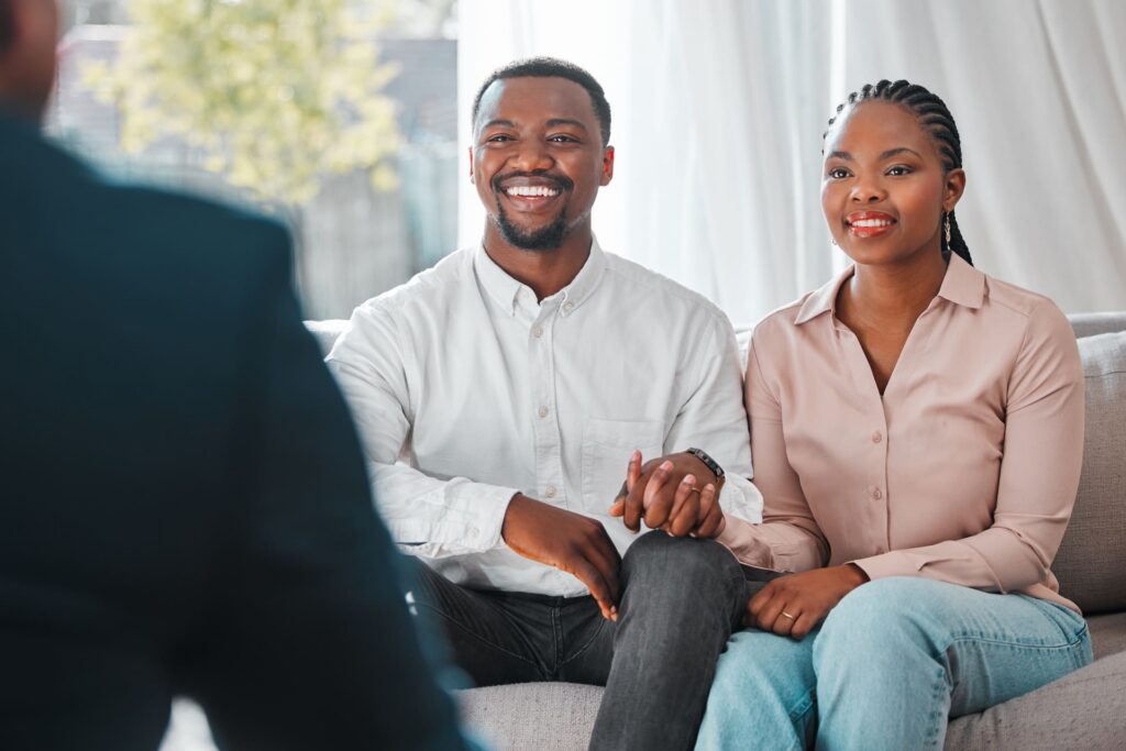 happy-couple-smiling-together-indoors-holding-hands speak with lawyer