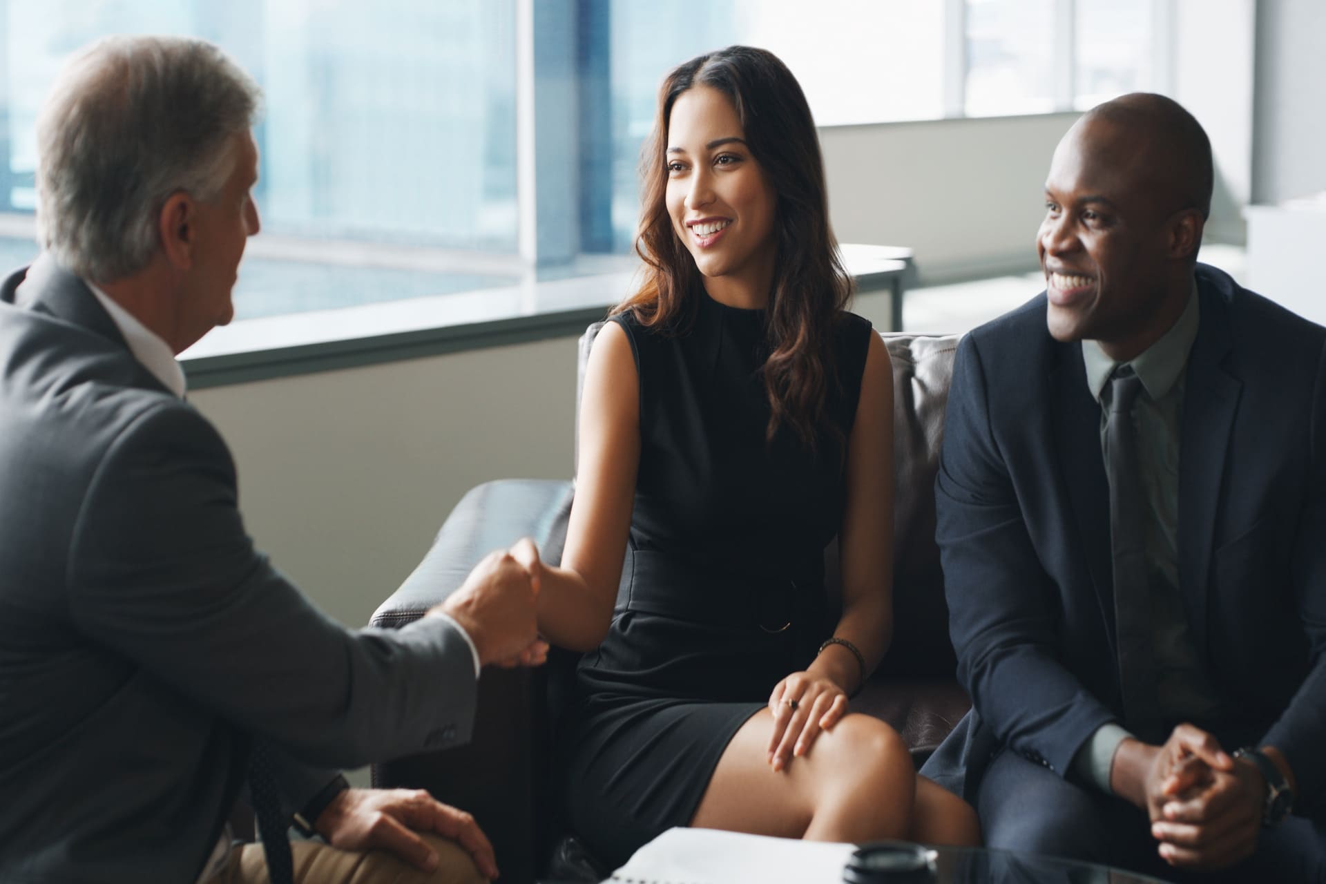 young couple shaking hand with lawyer