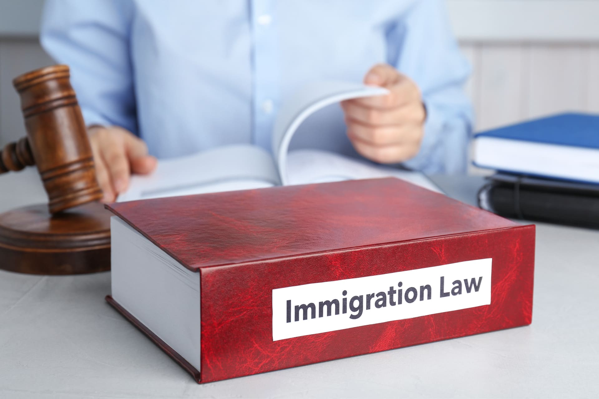 immigration-law-book-with-person-reading-nearby