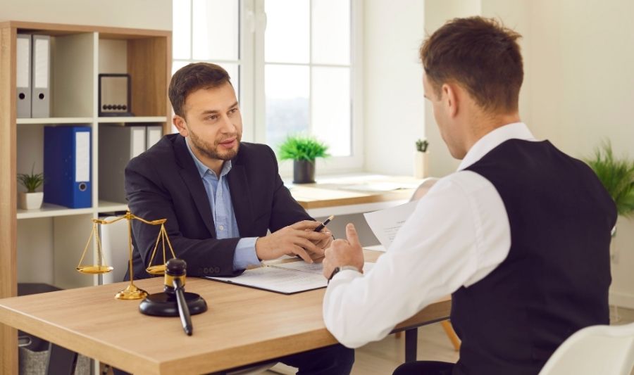 refugee talking to a lawyer about his proper documentation